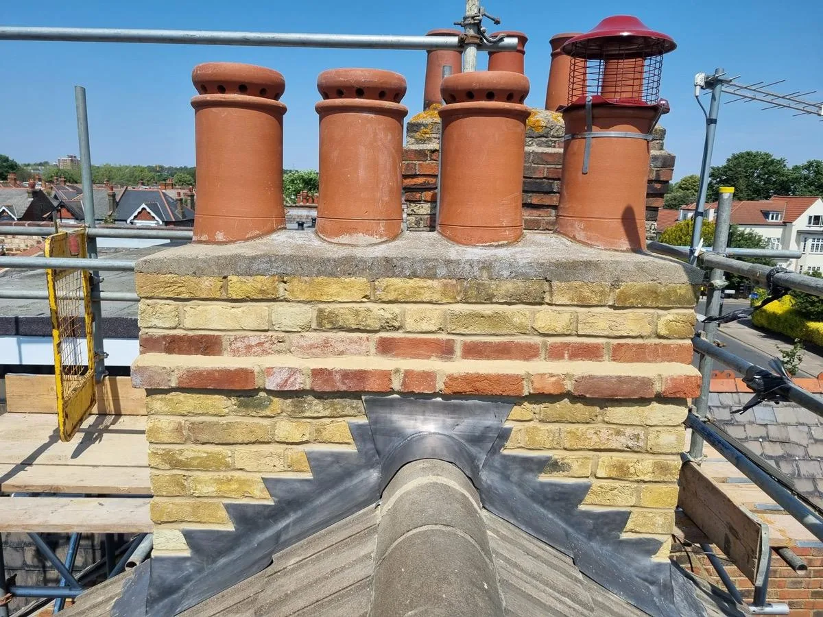 Chimney caps and lead flashing on a brick stack