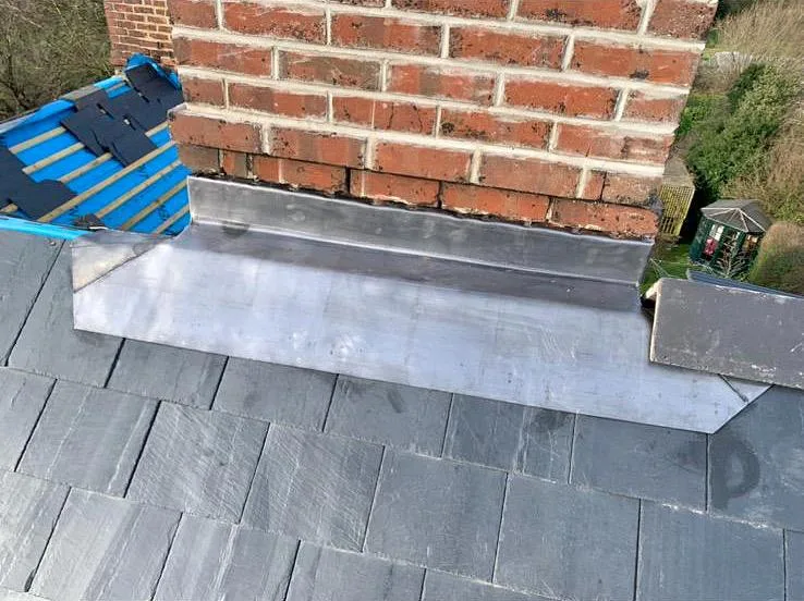Lead flashing at a brick wall and roof edge